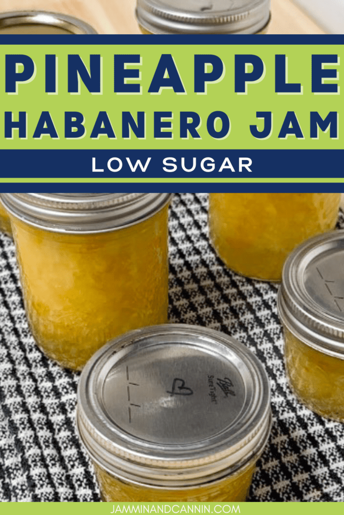 Image of 6 mason jars on a black and white checkered kitchen towel. The jars are filled with a yellow and orange filling. One lid has a heart drawn with a Sharpie. Lettering says, "Pineapple habanero jam, low sugar, JamminandCannin.com".