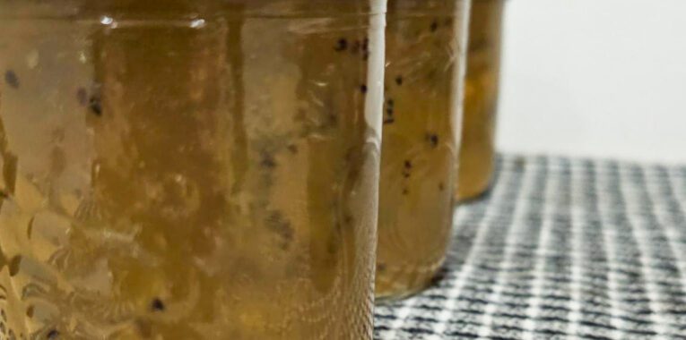 Image of three jars filled with kiwi preserves.